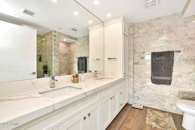 a bedroom with a bed and a flat screen television