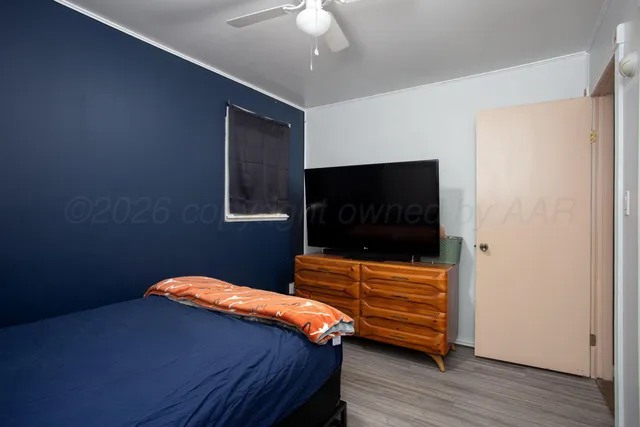 a bedroom with a bed and a flat screen tv