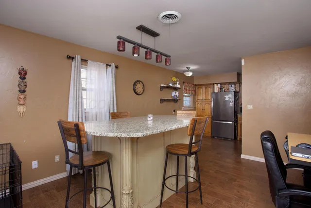 a view of a dining room with furniture and a chandelier