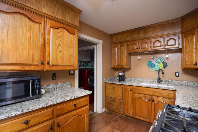 a kitchen with granite countertop stainless steel appliances a sink and counter space