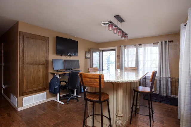 a dining room with furniture window and wooden floor