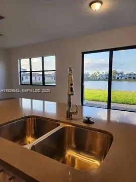 a kitchen with a sink and a large window