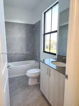 a bathroom with a toilet a sink and bathtub