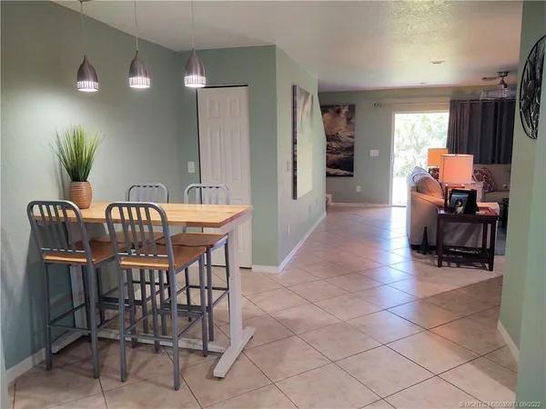 a living room with furniture a large window and a flat screen tv