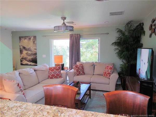 a living room with furniture and a large window