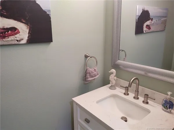 a bathroom with a sink a mirror and vanity