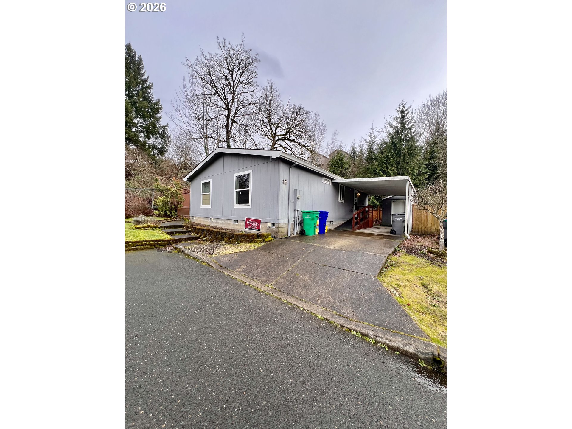 5200 Southeast 132nd Avenue, Unit 14 Portland, OR 97236 - Photo 1 of 17 a view of a house with a small yard and large tree