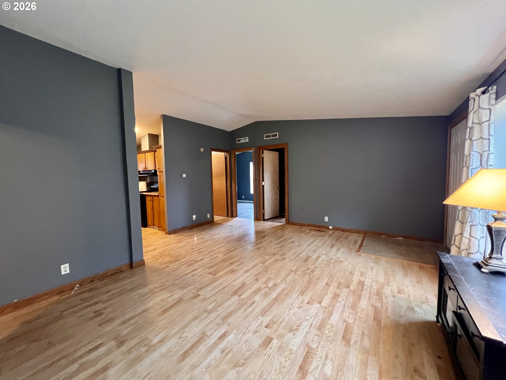 5200 Southeast 132nd Avenue, Unit 14 Portland, OR 97236 - Photo 4 of 17 a view of an empty room with wooden floor and a window
