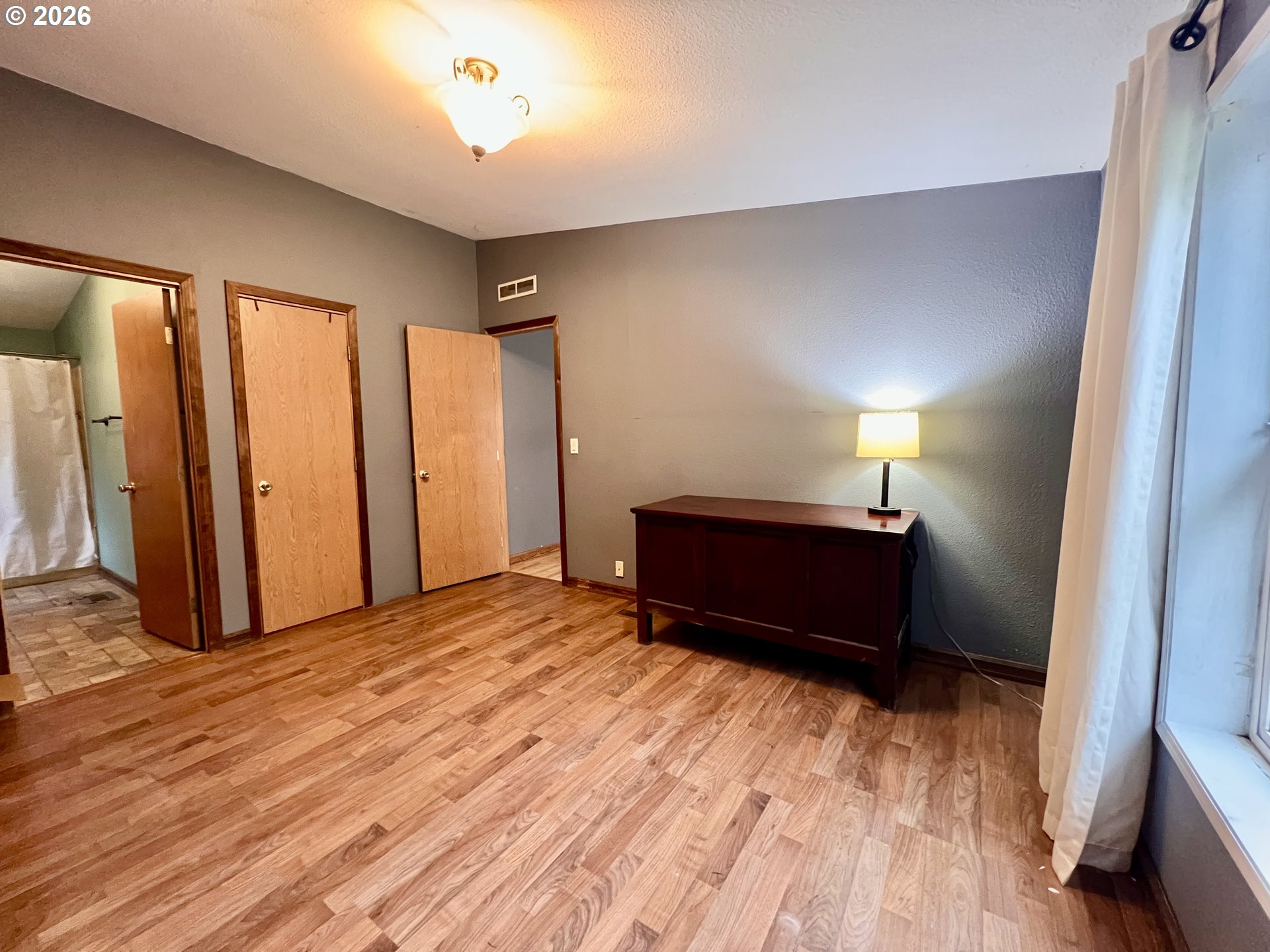 5200 Southeast 132nd Avenue, Unit 14 Portland, OR 97236 - Photo 9 of 17 a view of a room with wooden floor closet and a window