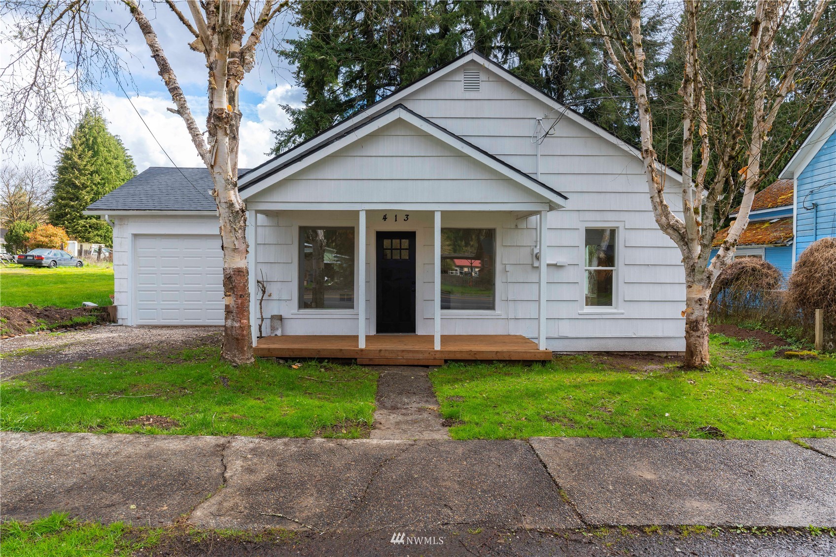 413 West 4th Avenue Pe Ell, WA 98572 - Photo 1 of 32 a front view of a house with a yard and a garage