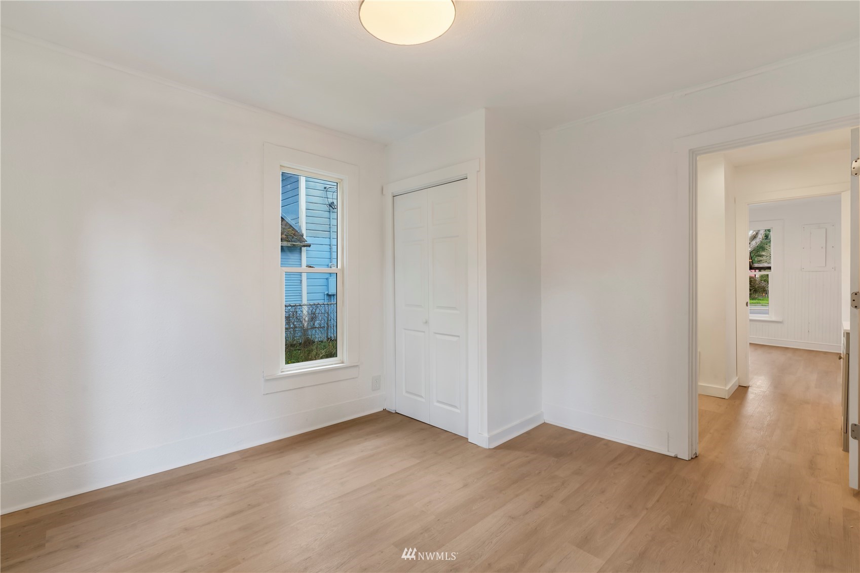 413 West 4th Avenue Pe Ell, WA 98572 - Photo 12 of 32 an empty room with wooden floor and windows