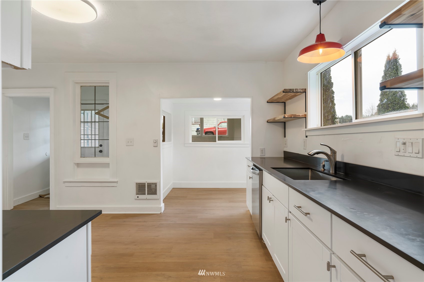 413 West 4th Avenue Pe Ell, WA 98572 - Photo 16 of 32 a kitchen with granite countertop a stove a sink and a refrigerator