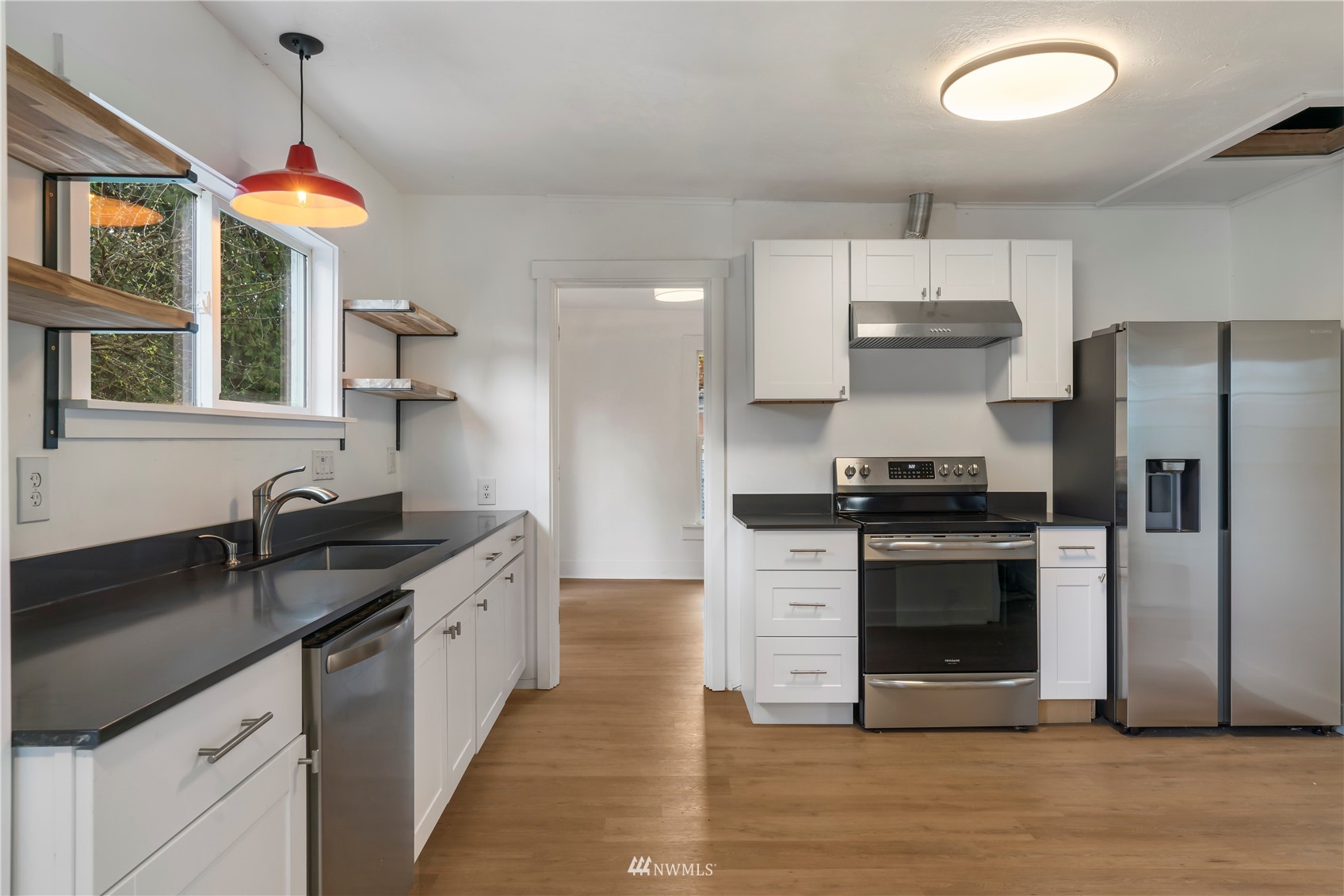 413 West 4th Avenue Pe Ell, WA 98572 - Photo 19 of 32 a kitchen with stainless steel appliances granite countertop a sink a stove and a refrigerator