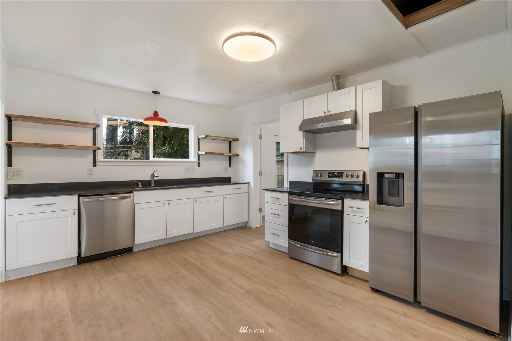 413 West 4th Avenue Pe Ell, WA 98572 - Photo 21 of 32 a kitchen with granite countertop stainless steel appliances a sink and cabinets