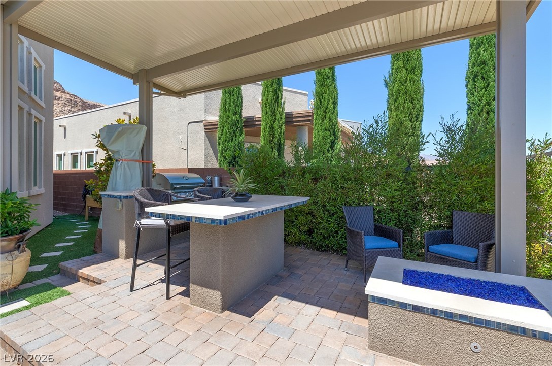 6014 Willow Ridge Court Las Vegas, NV 89135 - Photo 72 of 99 An inviting outdoor patio features a built-in barbecue and a cozy fire pit.
