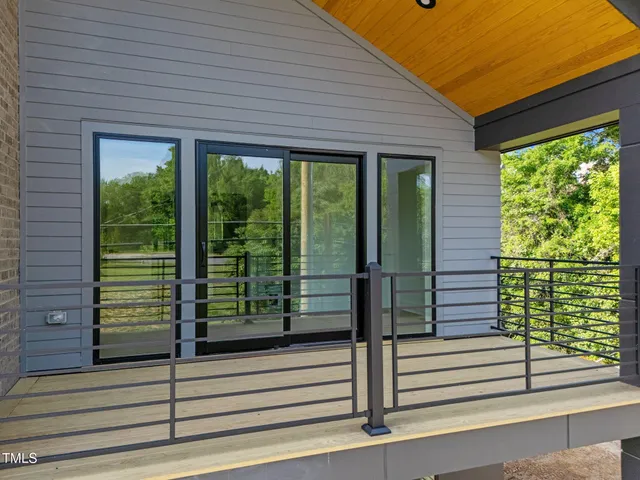 a view of a hallway with furniture and windows