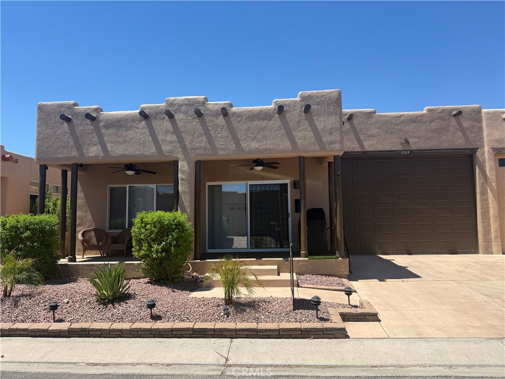 1164 Beach Drive Needles, CA 92363 - Photo 1 of 1 a front view of a house with windows and plants