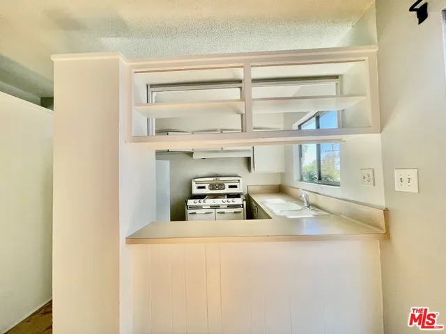 a kitchen with a stove and a refrigerator