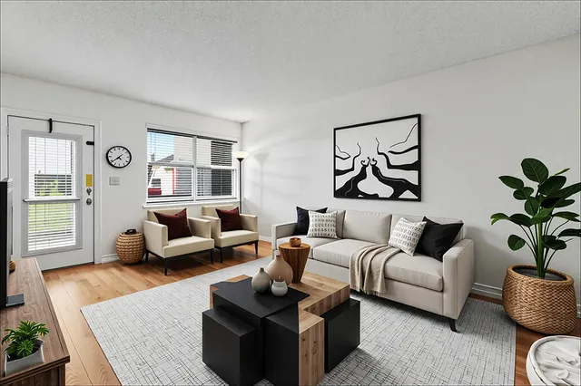 a living room with furniture and wooden floor