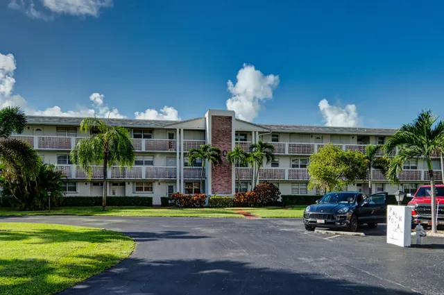 a front view of a house with swimming pool having outdoor seating