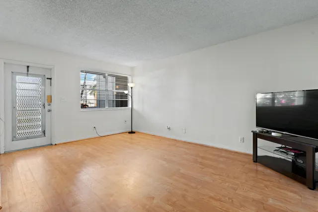 a view of a livingroom with furniture and a flat screen tv