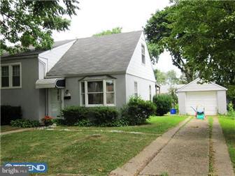 8615 Old Line Road Philadelphia, PA 19128 - Photo 1 of 12 a front view of a house with a yard and trees
