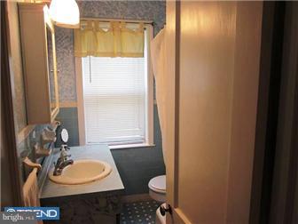 8615 Old Line Road Philadelphia, PA 19128 - Photo 12 of 12 a bathroom with a sink toilet and mirror
