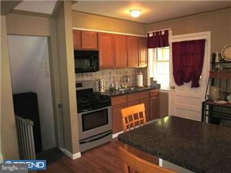 8615 Old Line Road Philadelphia, PA 19128 - Photo 6 of 12 a kitchen with stainless steel appliances granite countertop a stove a sink and a refrigerator