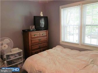 8615 Old Line Road Philadelphia, PA 19128 - Photo 9 of 12 a bedroom with a bed and flat tv screen on the dresser