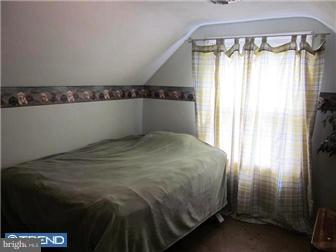 8615 Old Line Road Philadelphia, PA 19128 - Photo 10 of 12 a bedroom with a bed and a window