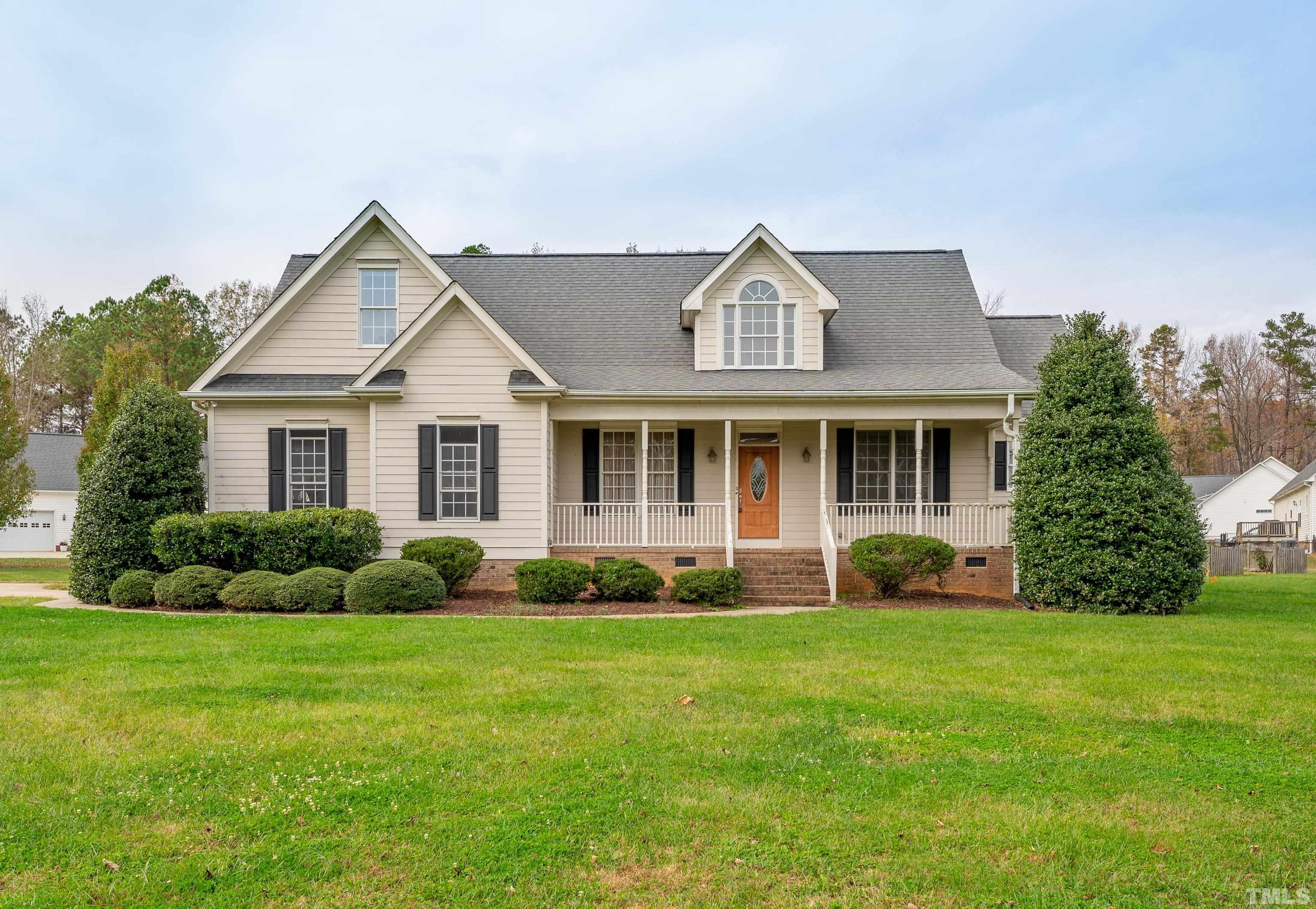 134 Fletcher Ridge Road Timberlake, NC 27583 - Photo 1 of 52 a front view of a house with a yard and garage