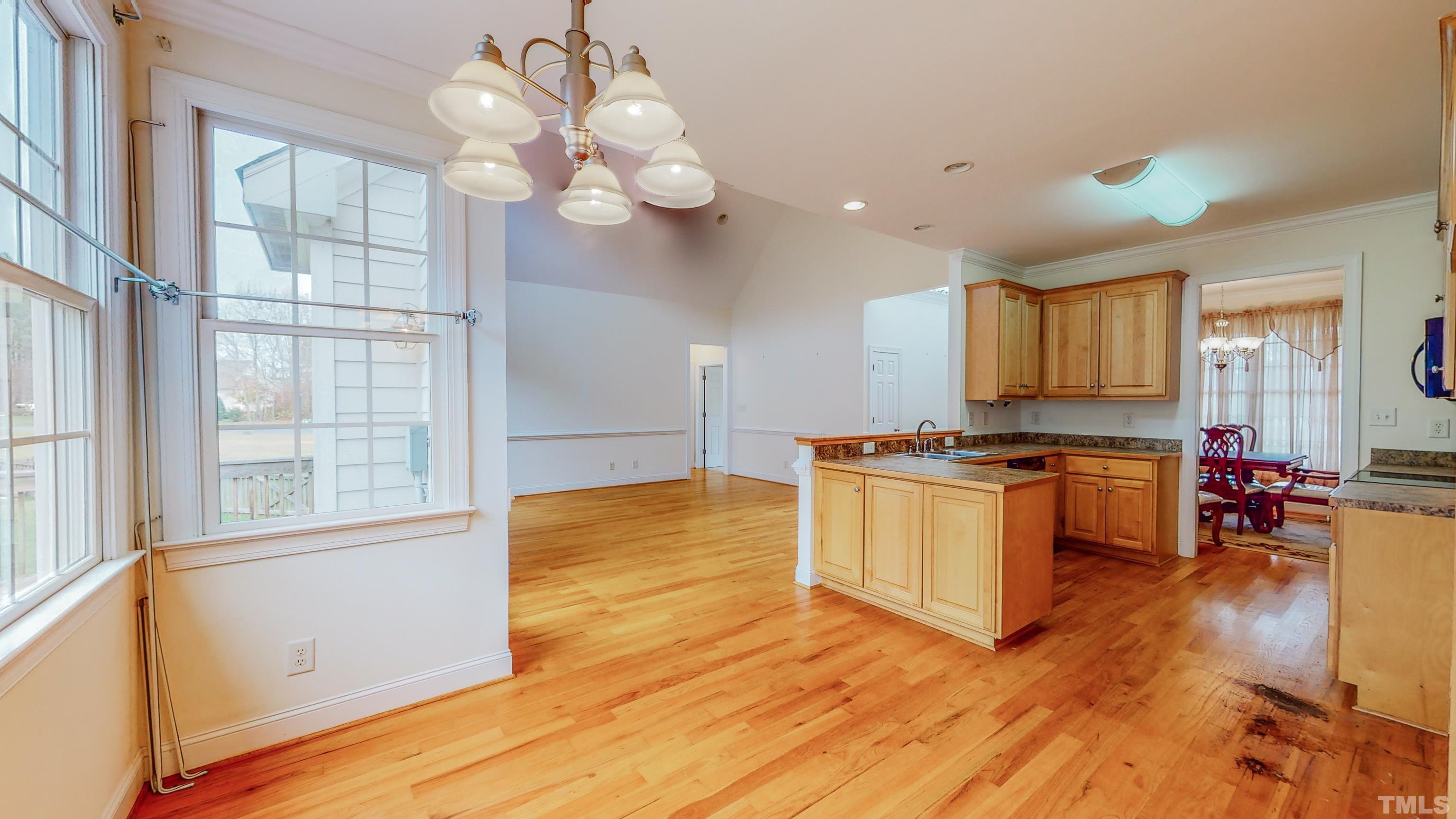 134 Fletcher Ridge Road Timberlake, NC 27583 - Photo 11 of 52 a kitchen with stainless steel appliances granite countertop a sink cabinets and wooden floor