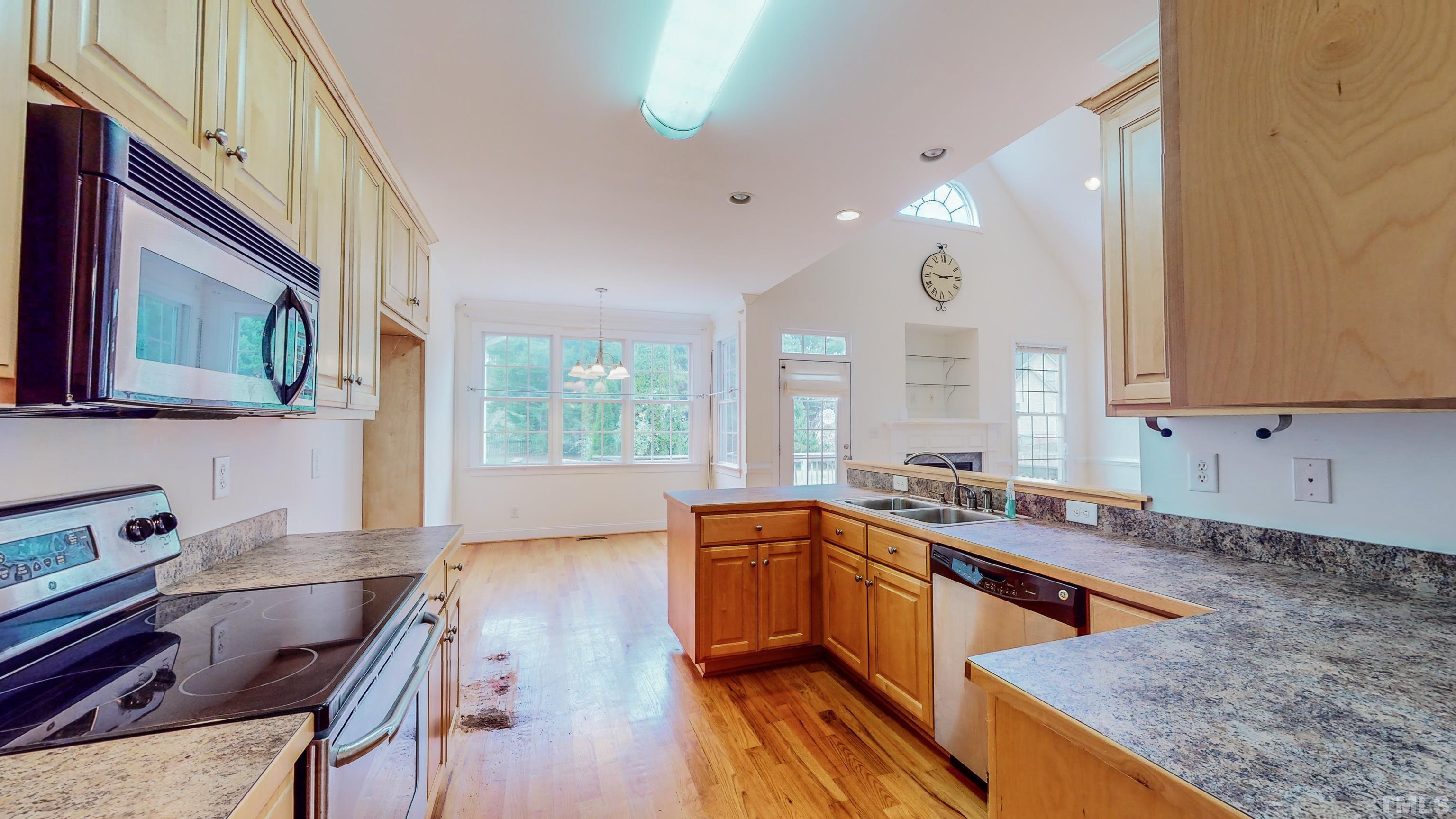 134 Fletcher Ridge Road Timberlake, NC 27583 - Photo 13 of 52 a kitchen with lots of counter top space and wooden floor