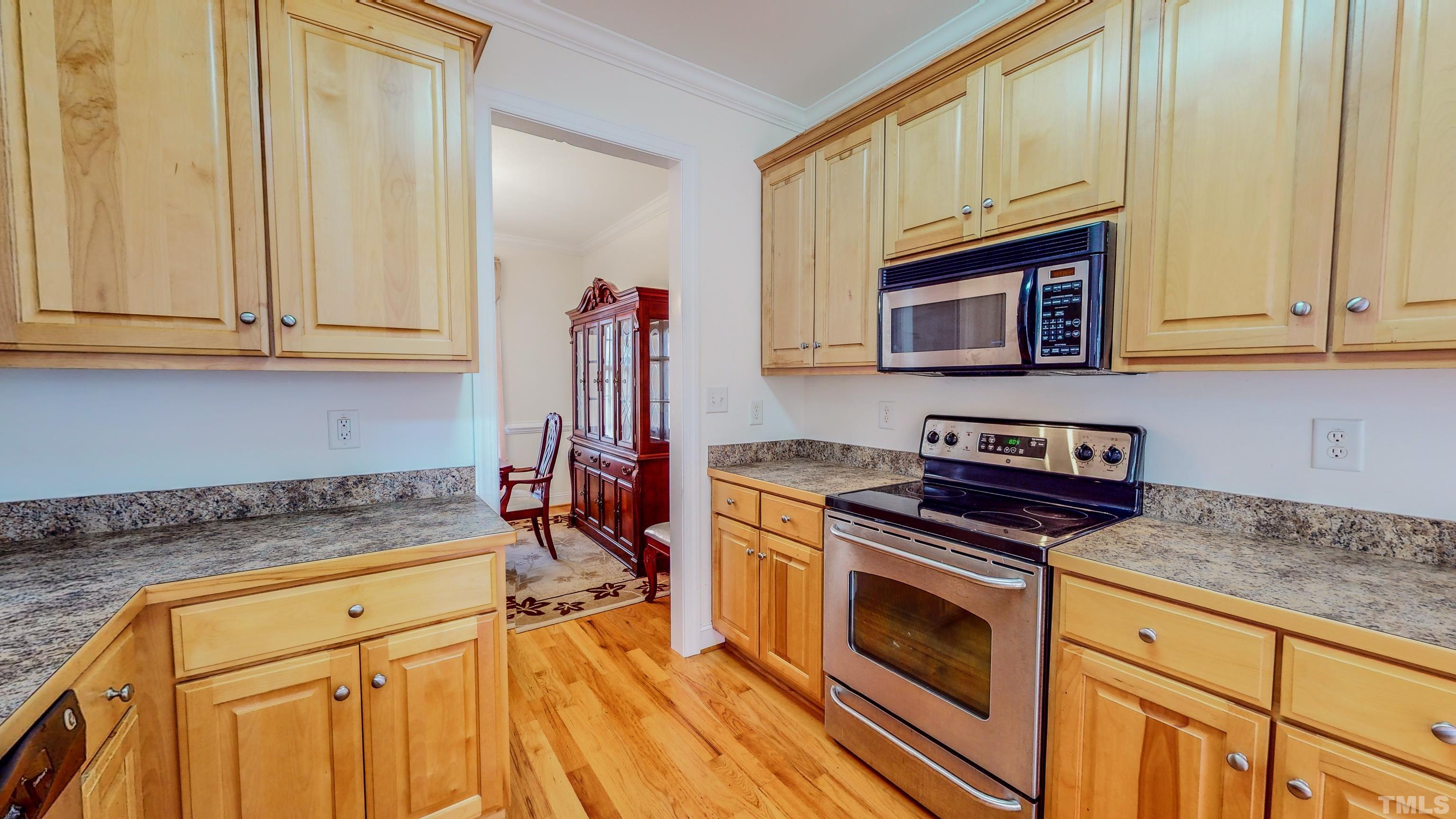 134 Fletcher Ridge Road Timberlake, NC 27583 - Photo 14 of 52 a kitchen with granite countertop a stove and a sink