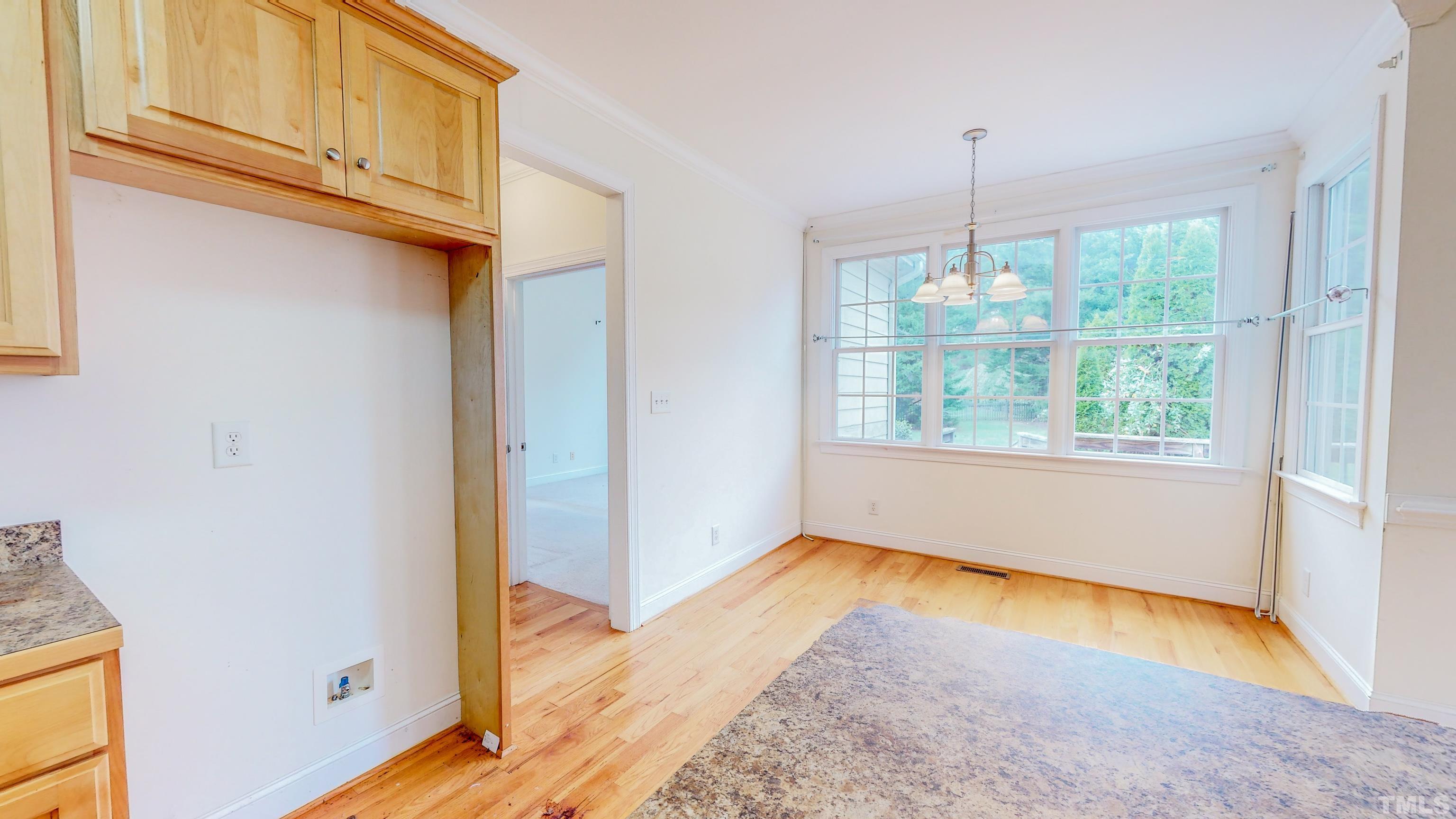 134 Fletcher Ridge Road Timberlake, NC 27583 - Photo 16 of 52 a view of an empty room with window wooden floor and door
