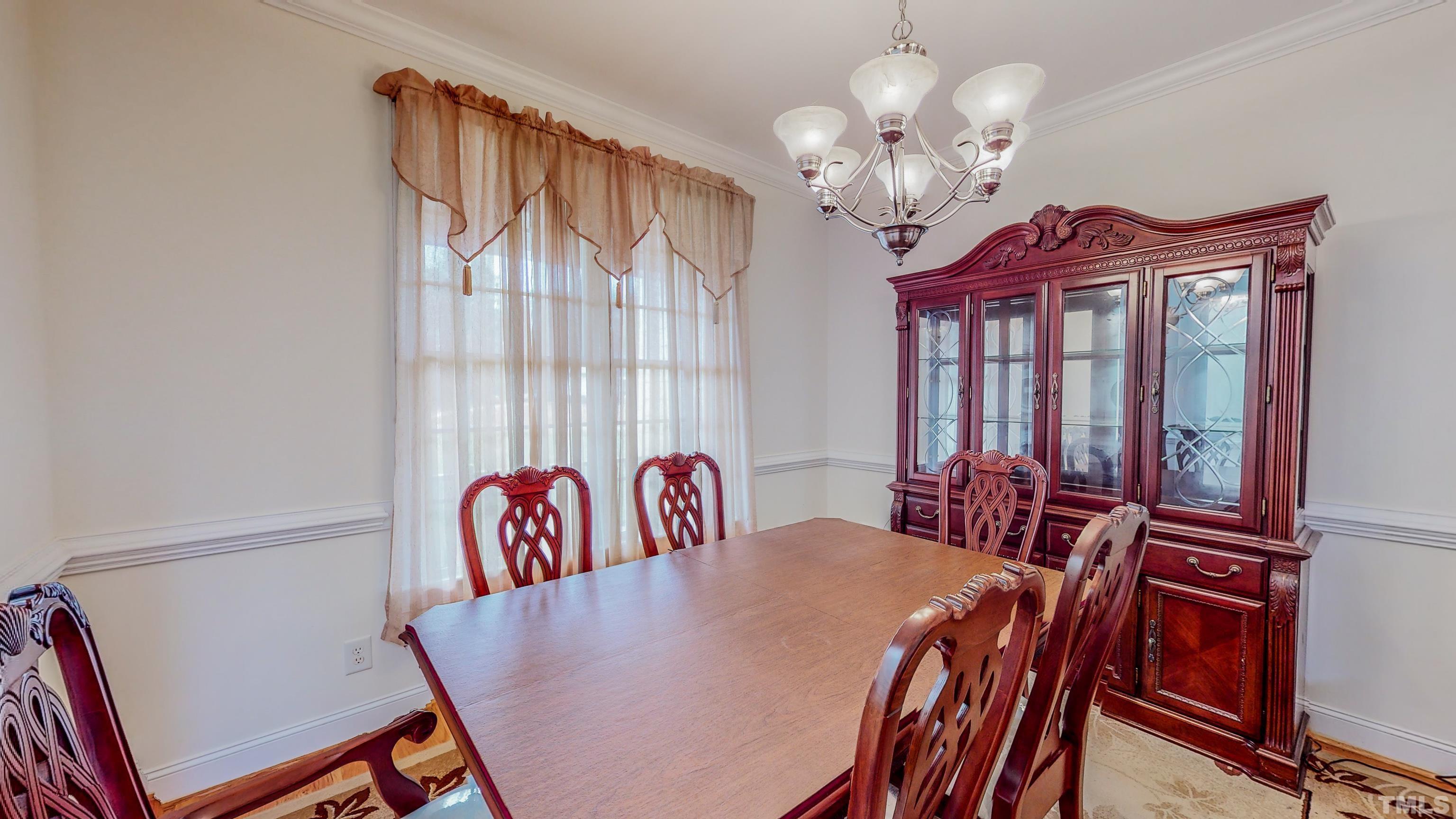 134 Fletcher Ridge Road Timberlake, NC 27583 - Photo 18 of 52 a view of a dining room with furniture and a chandelier