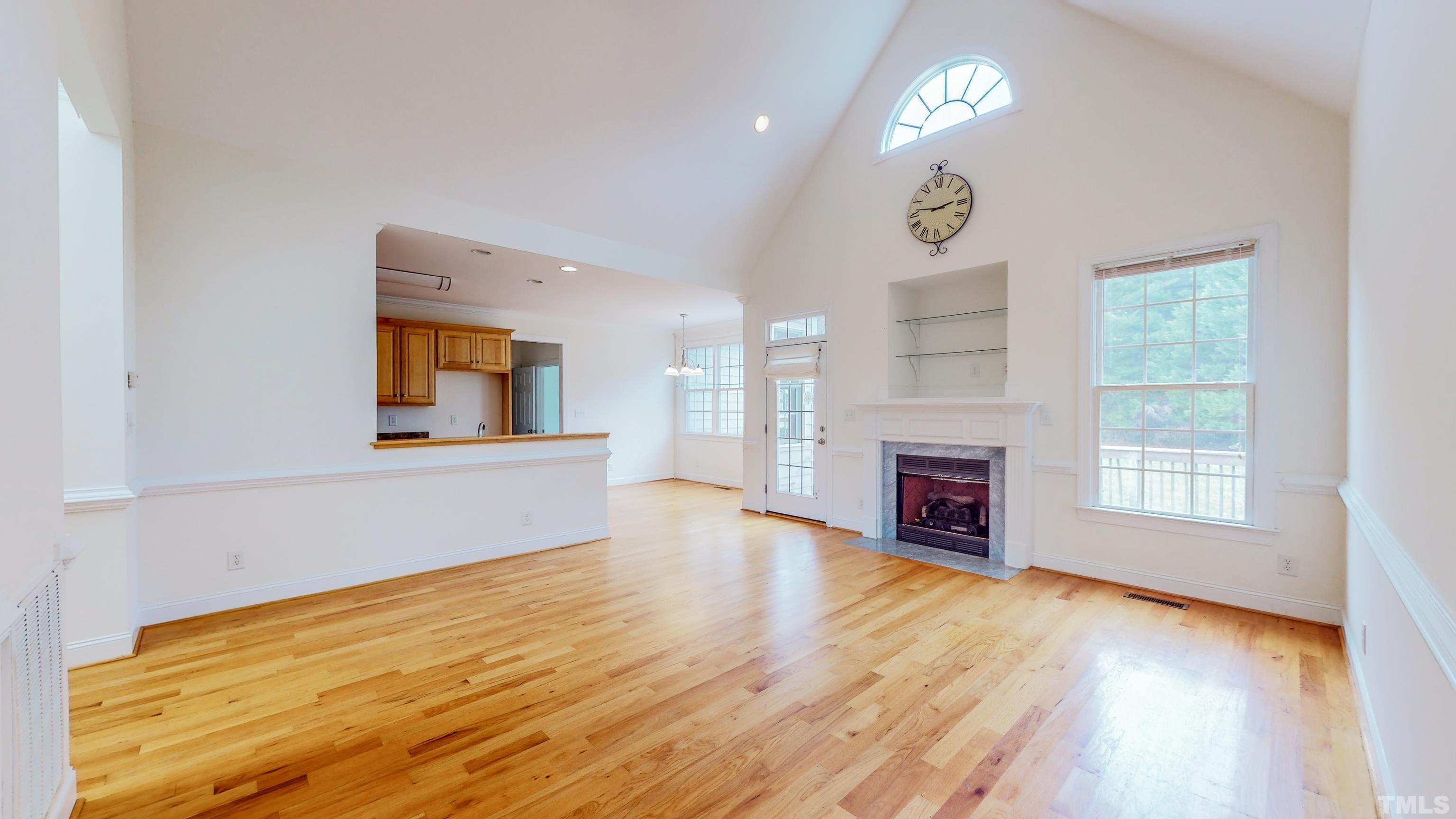 134 Fletcher Ridge Road Timberlake, NC 27583 - Photo 2 of 52 a view of a livingroom with a fireplace a chandelier and wooden floor