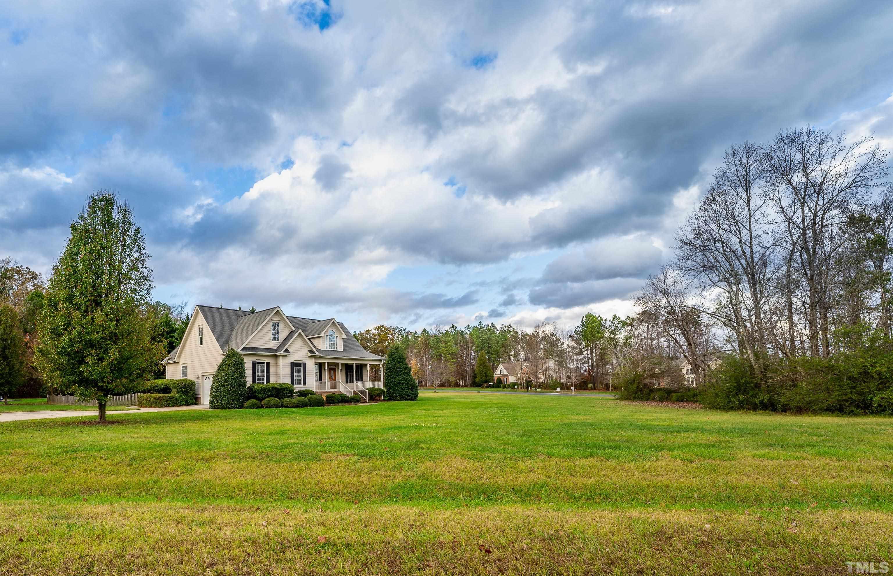 134 Fletcher Ridge Road Timberlake, NC 27583 - Photo 21 of 52 a view of a big house with a big yard and a large trees
