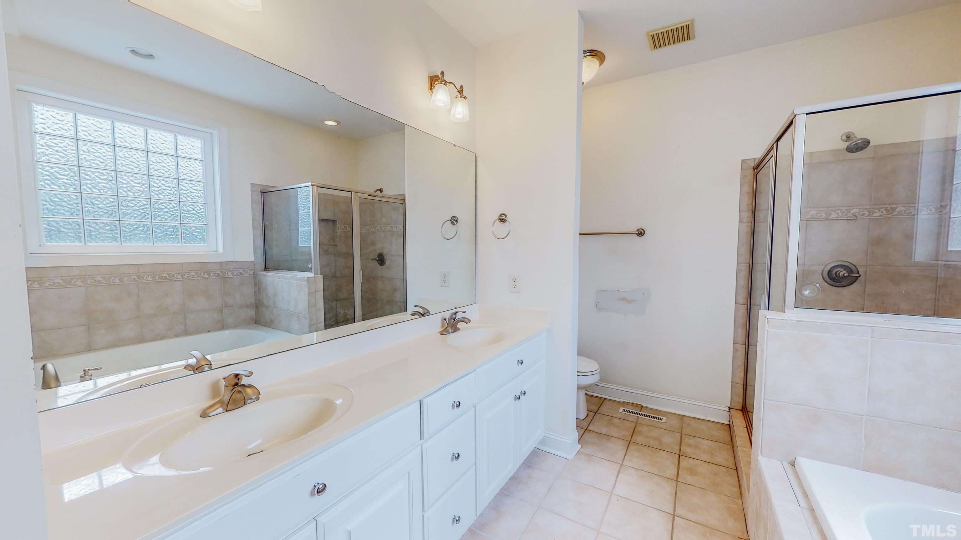 134 Fletcher Ridge Road Timberlake, NC 27583 - Photo 26 of 52 a bathroom with a shower sink and mirror