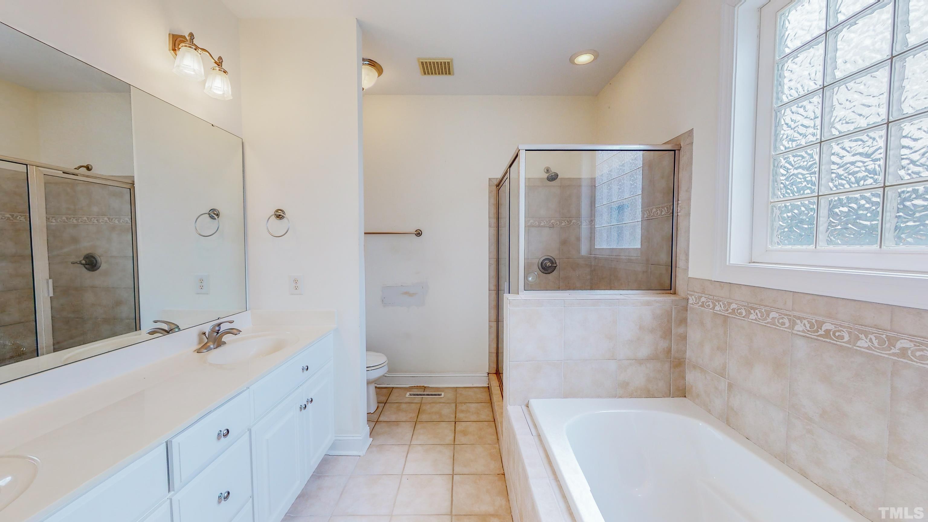 134 Fletcher Ridge Road Timberlake, NC 27583 - Photo 27 of 52 a bathroom with a tub shower sink and mirror