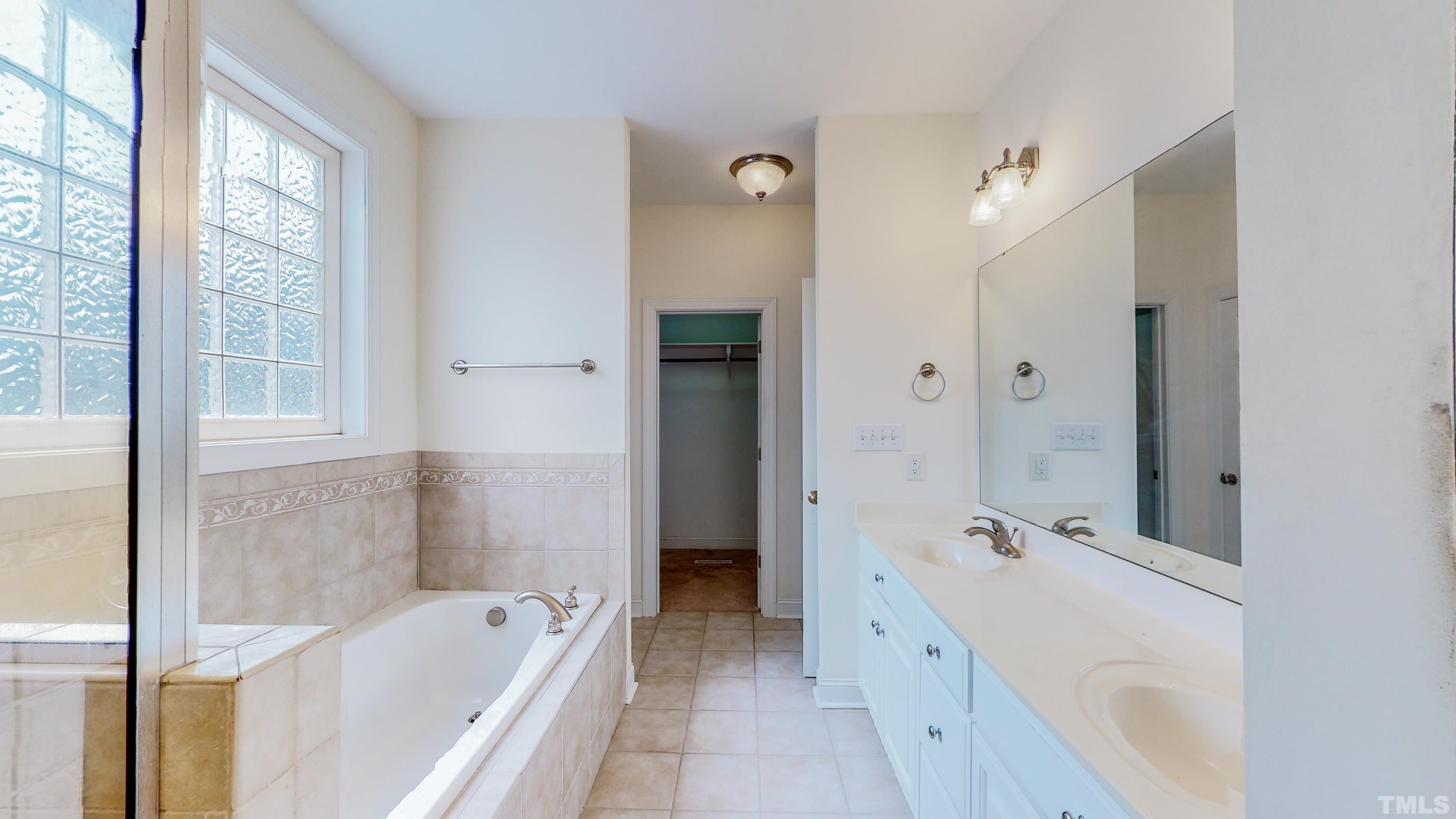 134 Fletcher Ridge Road Timberlake, NC 27583 - Photo 28 of 52 a bathroom with a tub sink and mirror