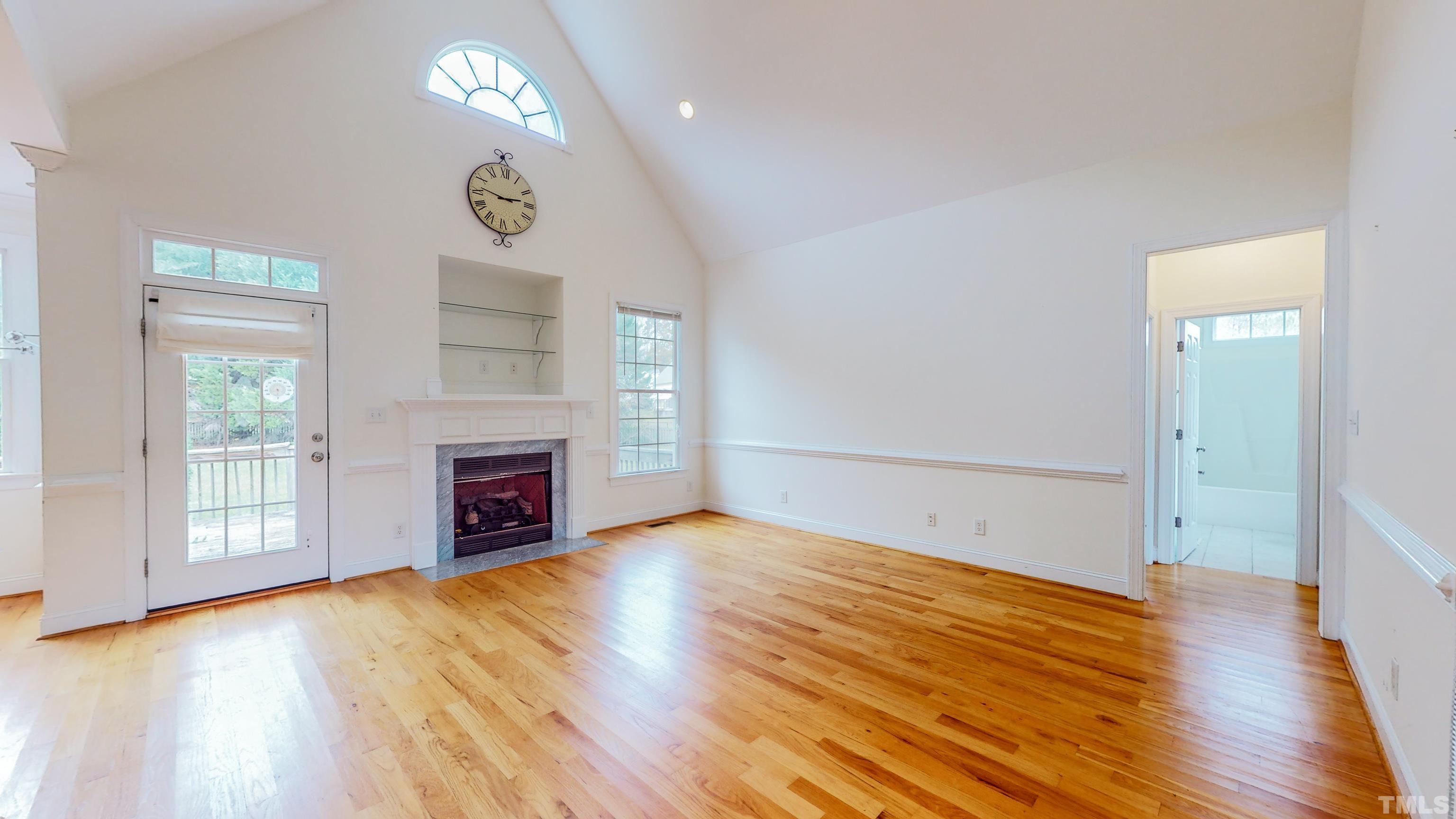 134 Fletcher Ridge Road Timberlake, NC 27583 - Photo 32 of 52 an empty room with windows fireplace and wooden floor