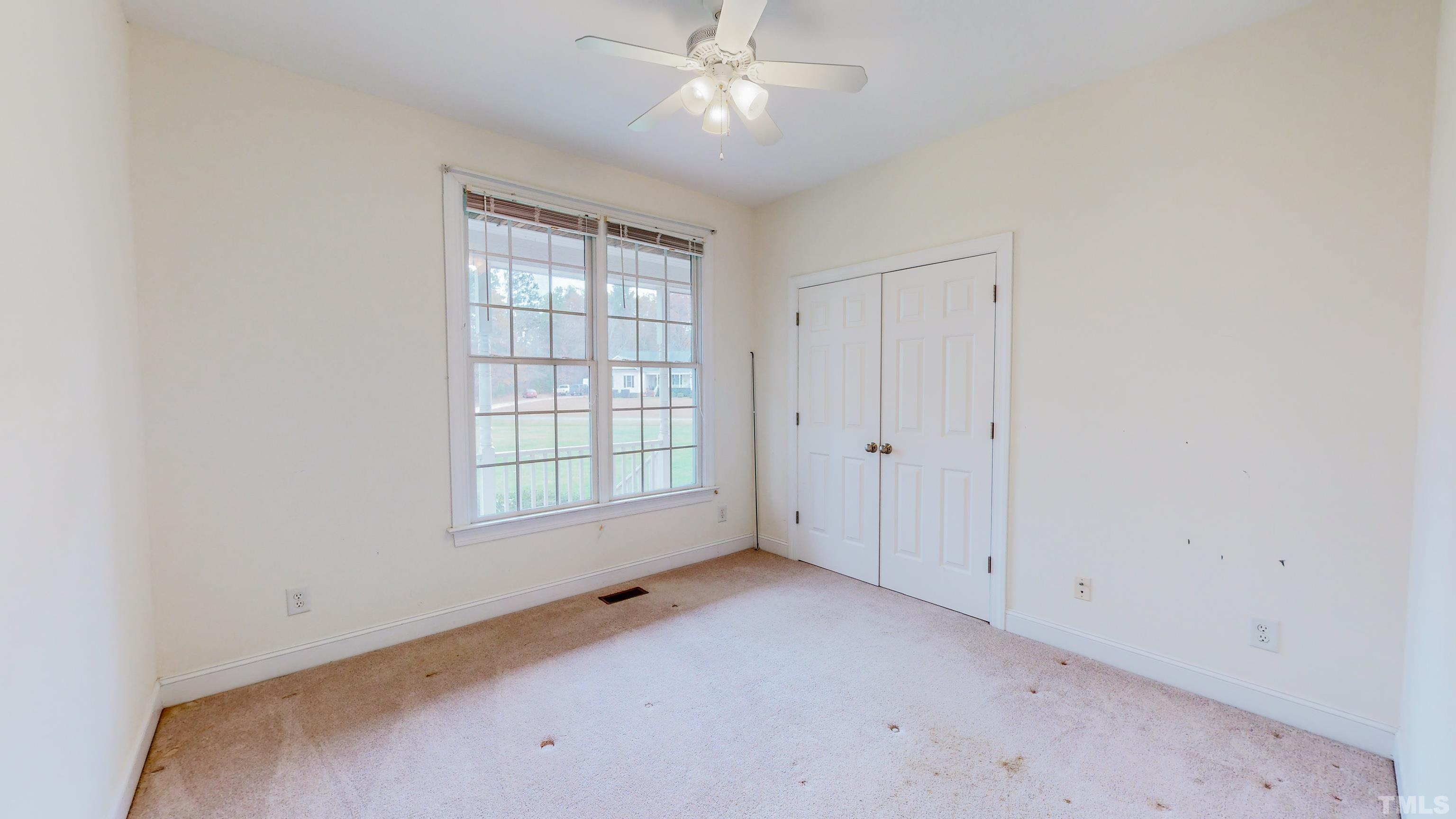 134 Fletcher Ridge Road Timberlake, NC 27583 - Photo 34 of 52 an empty room with chandelier fan and windows