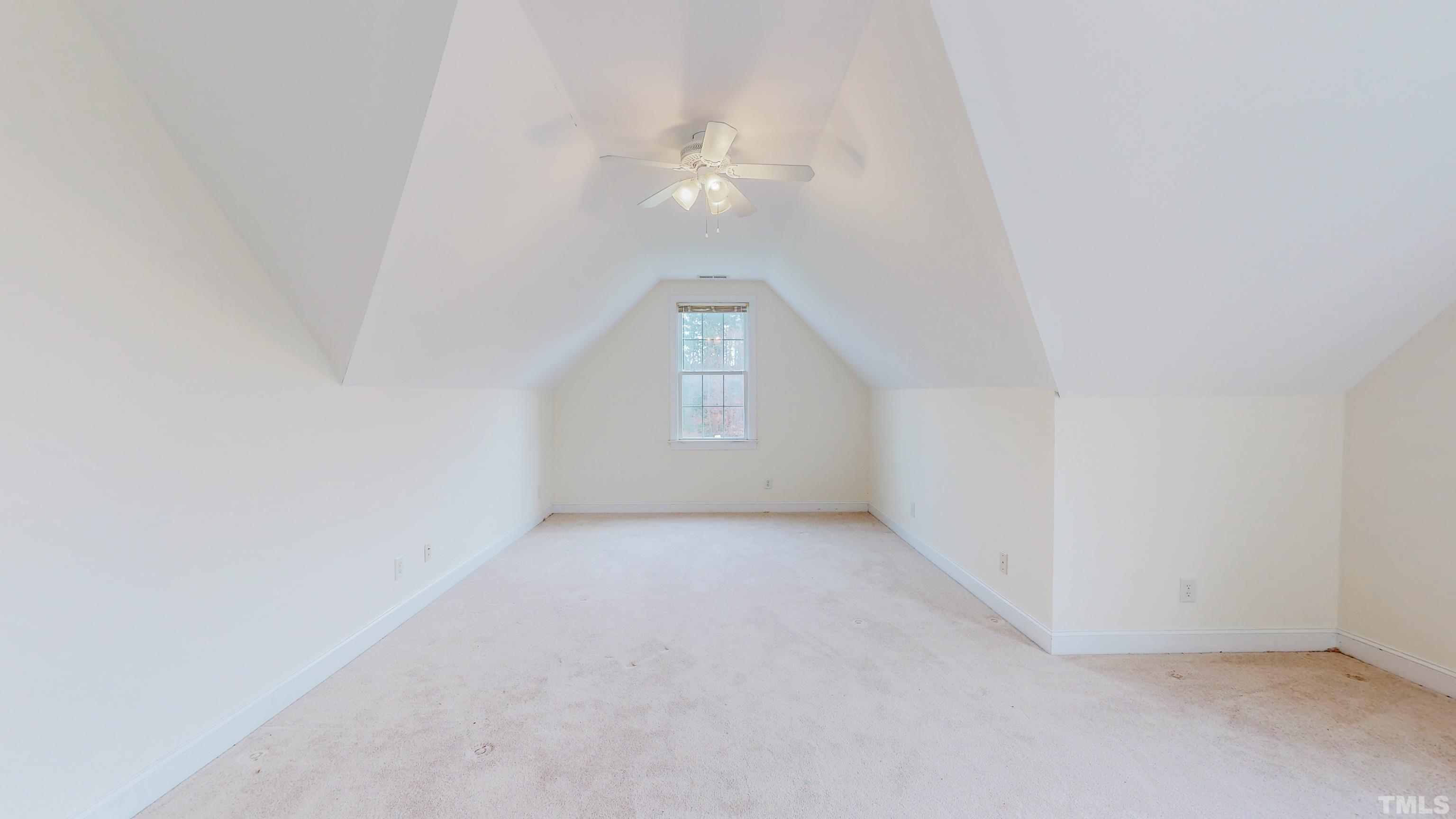 134 Fletcher Ridge Road Timberlake, NC 27583 - Photo 36 of 52 an empty room with a chandelier fan and windows