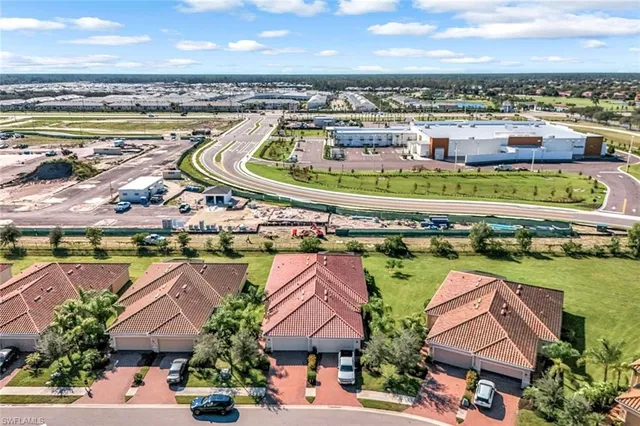 an aerial view of residential houses with outdoor space and ocean view