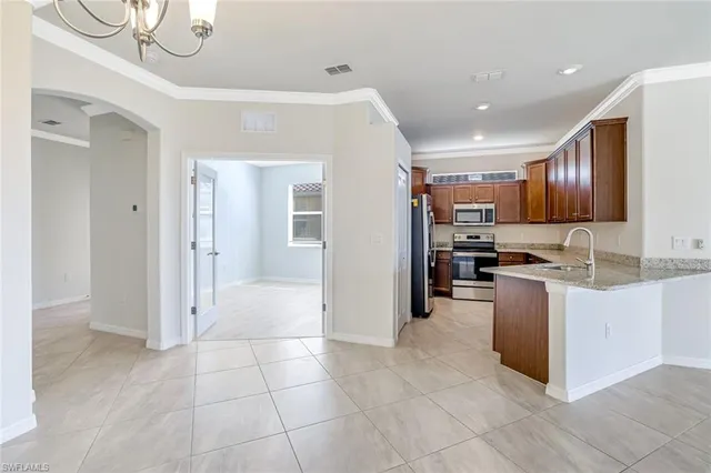a kitchen with stainless steel appliances granite countertop a refrigerator and a sink
