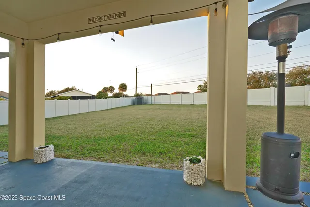 a living room with a floor to ceiling window and pool table