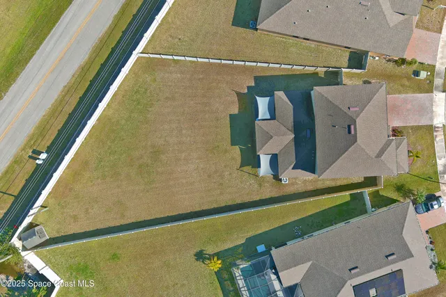 an aerial view of a house with a swimming pool