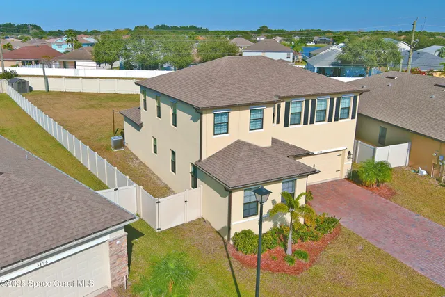a aerial view of a house with a yard