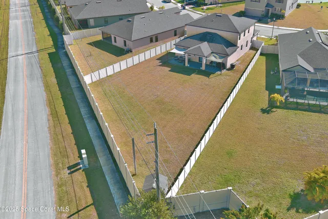 an aerial view of a house with swimming pool